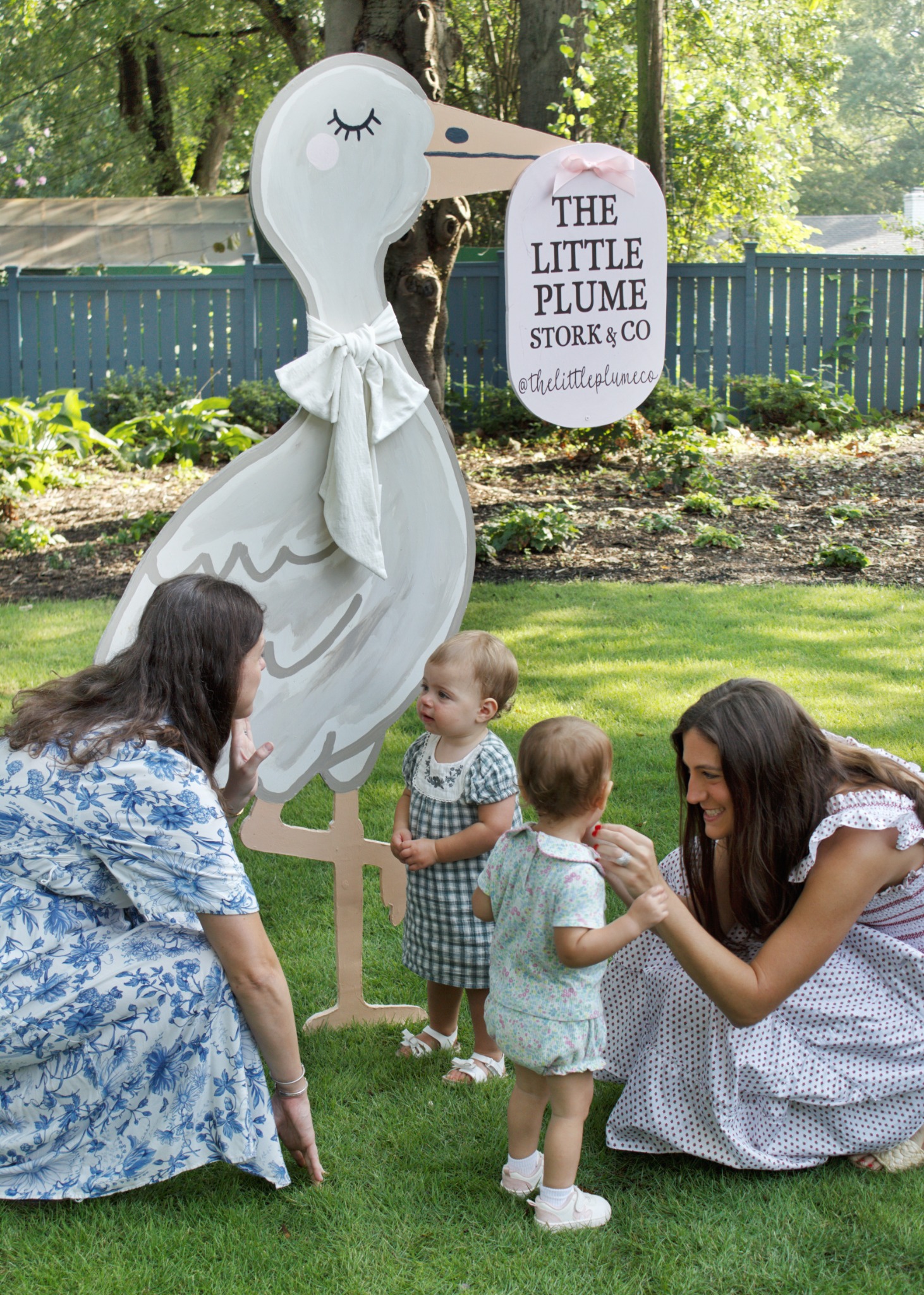 The Little Plume founders with their daughters beside their stork